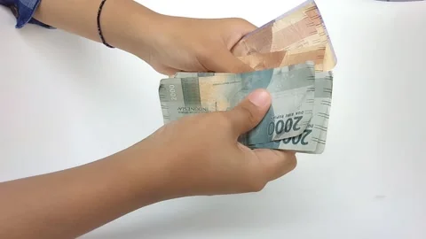Counting Rupiah on a white background Stock Footage 219217390