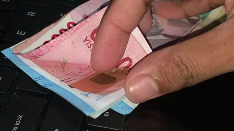 Counting a stack of paper money Stock Footage 309003475