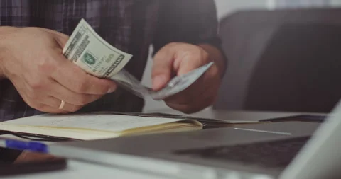 Counting US dollar bills at desk Stock Footage 320945569