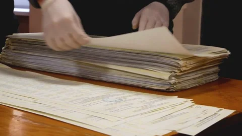 Counting votes in elections. Man in gloves shifting ballots Stock-Footage 171650849
