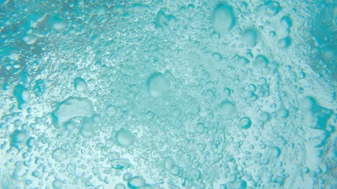 Countless bubbles swirl and float up and away from camera in slow motion 스톡 동영상 248081014