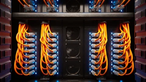 Countless orange cables in a  server cabinet lit by a single spotlight. 4KHD Stock Footage 126261929
