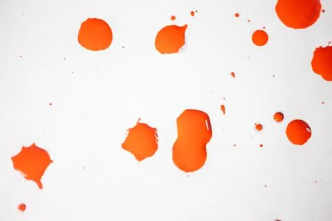 Countless splashes of red paint of various sizes are scattered across. Stock Photos
