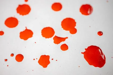 Countless splashes of red paint of various sizes are scattered across. Stock Photos