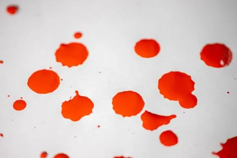 Countless splashes of red paint of various sizes are scattered across. Stock Photos