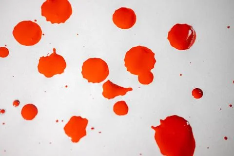 Countless splashes of red paint of various sizes are scattered across. Stock Photos