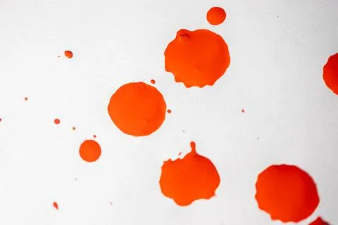 Countless splashes of red paint of various sizes are scattered across. Stock Photos