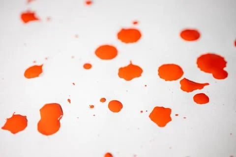 Countless splashes of red paint of various sizes are scattered across. Stock Photos