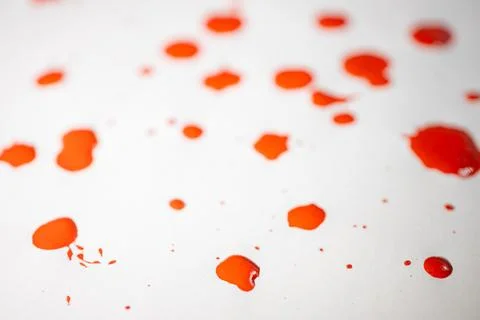 Countless splashes of red paint of various sizes are scattered across. Stock Photos
