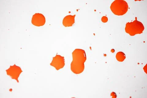 Countless splashes of red paint of various sizes are scattered across. Stock Photos