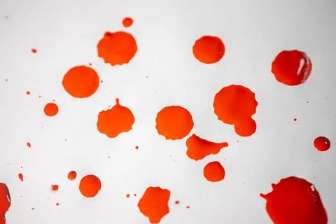 Countless splashes of red paint of various sizes are scattered across. Stock Photos