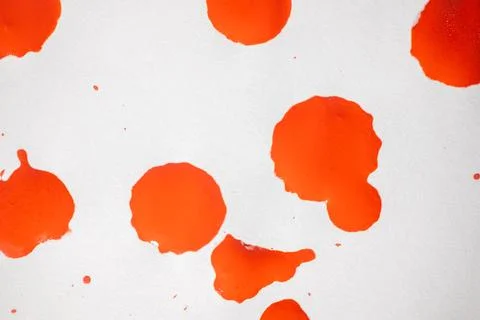 Countless splashes of red paint of various sizes are scattered across. Stock Photos