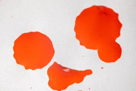 Countless splashes of red paint of various sizes are scattered across. Stock Photos