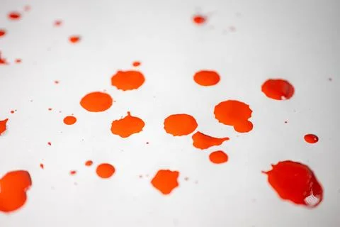 Countless splashes of red paint of various sizes are scattered across. Stock Photos
