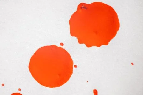 Countless splashes of red paint of various sizes are scattered across. Stock Photos