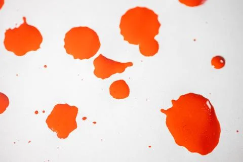 Countless splashes of red paint of various sizes are scattered across. Stock Photos
