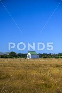 Country church and farm fields Stock Photos