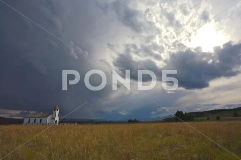 Country church with storm clouds Stock Photos
