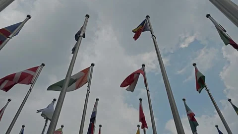 Country Flags Fluttering Strong in the Wind on a Clear Day Stock Footage 283956828
