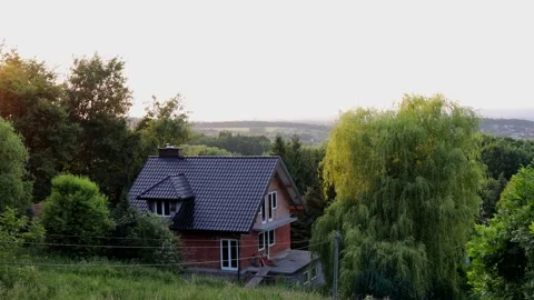 Country house under construction surrounded by dense green trees with sceni.. Stock Footage 313451713