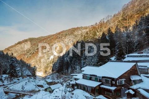 Country houses and forest hills in winter, japan Stock Photos