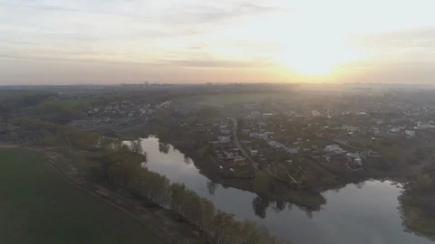 A country lake in the rays of the setting sun. The village is out of town. Stock Footage 91544889