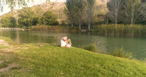 Country reading by the river Stock Footage 124382595