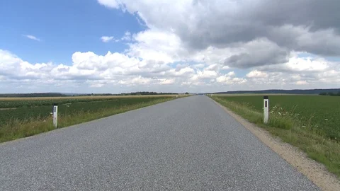 Country road with dramatic sky car passing Stock Footage 78089599