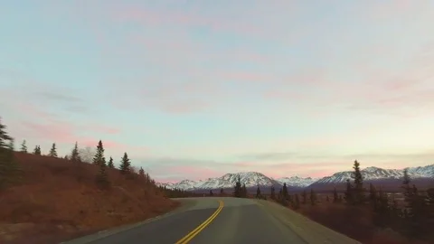 Country road passing through forest and mountainous region during sunset 스톡 동영상 79657597