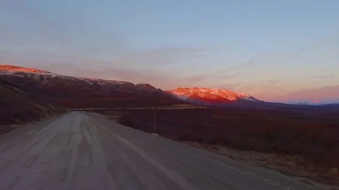 Country road passing through mountainous region during sunset 스톡 동영상 79657201