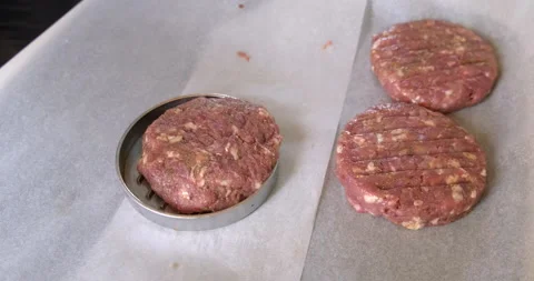 In Country Setting Prepares Meat Cutlets. Throws Forcemeat into Round Metal Form Stock Footage 132474981