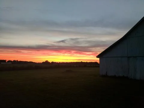 Country Sunset Behind a Barn Stock Photos