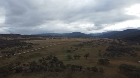 Countryside and Mountain Range Fly Over Stock Footage 239592705