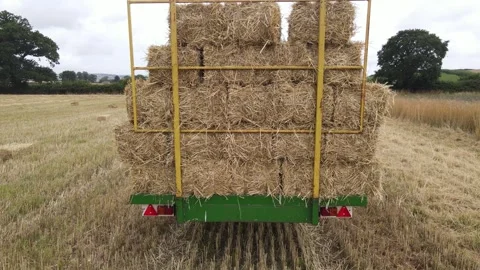 Countryside Drone Footage of Tractor Loading Hay Bales in Wheat Farm Stock Footage 332734007
