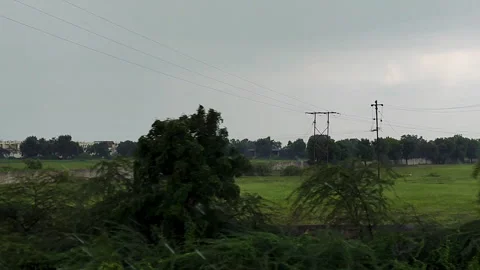 Countryside green fields view from moving train window in monsoon Video stock 316192447
