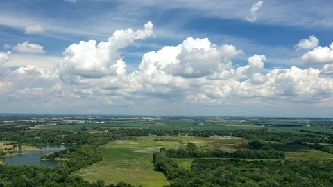 Countryside landscape of fields and sky during daytime, aerial time lapse Stock Footage 112914293