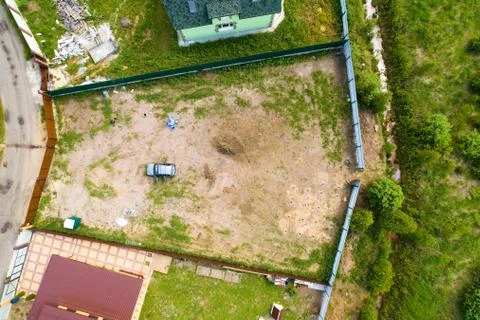 On the countryside private plot there is a car and a toilet cubicle. Stock Photos