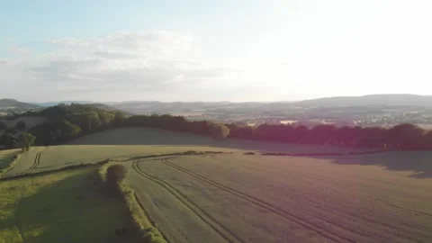 Countryside Scene at Sunset, Starting High Before Moving Behind a Large Tree 2K Stock Footage 239860152
