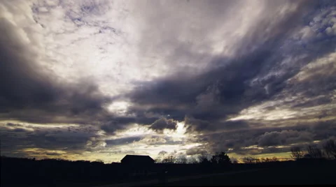 Countryside sun cloud time-laspe silhouetted farm and counrty horizon Sunset Stock Footage 63475479