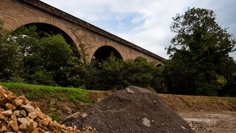 Countryside Timelapse, Clouds Passing Over Railway Bridge and Trees 4K Stock Footage 100021130