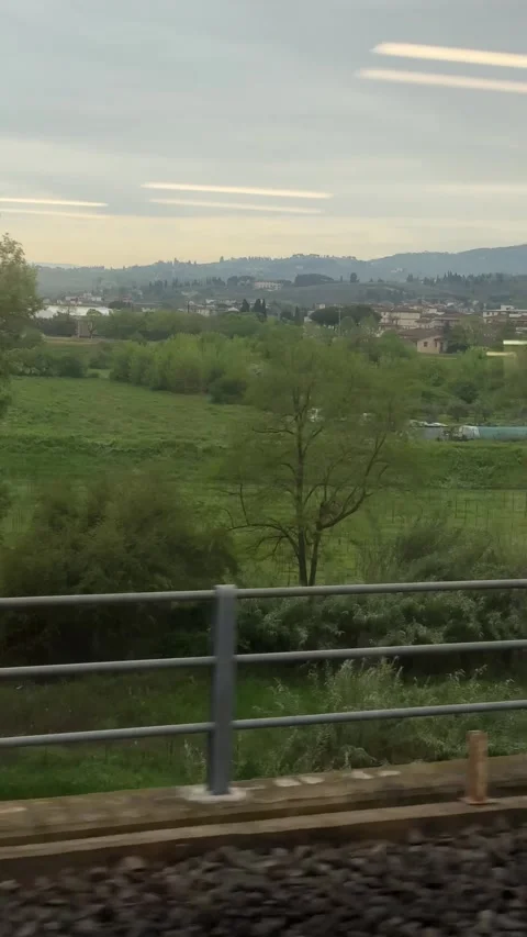 Countryside view from Pisa to Florence train in Tuscany on cloudy April day Stock Footage 306959835