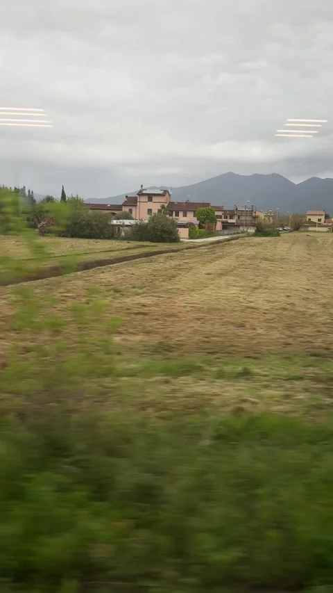 Countryside view from train between Pisa and Florence with fields and mountains Stock Footage 306959830