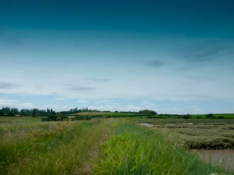 Countryside walking path outside through meadow Stock Photos