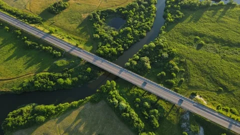Countryside. A wide canal that flows between fields and forests and a highway Stock Footage 167252560