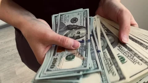Counts hundred dollar bills Stock Footage 304663237