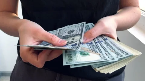Counts hundred dollar bills Stock Footage 304663823