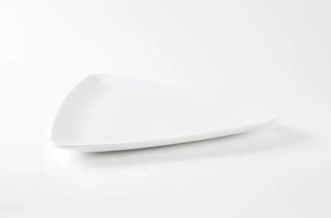 Coupe shaped triangle white dinner plate Stock Photos
