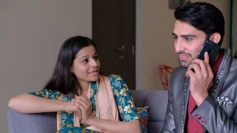 Coupe talking on the phone gets some get good news as they share and talk and bo Stock Footage 101335821