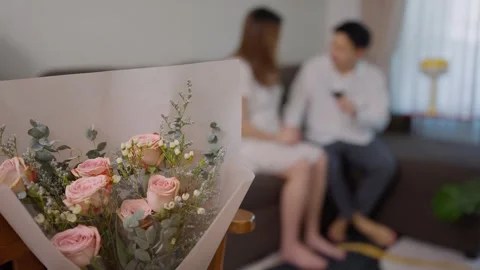 A coupl sitting and talking together on a sofa at home, Love on Valentine’s Day. 動画素材 327849120
