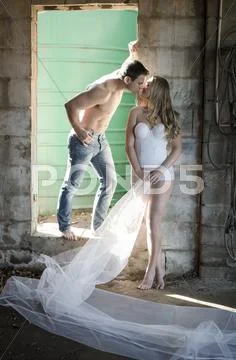 Couple About To Kiss In A Run Down Building.